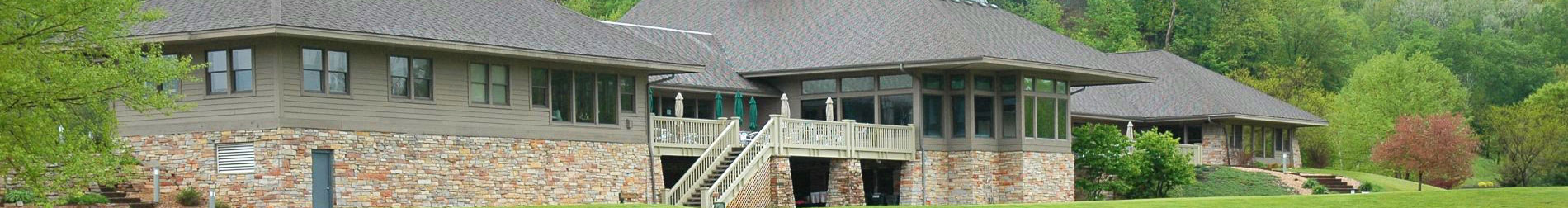 A serene modern single-story house showcasing a blend of stone and wood in a lush setting.